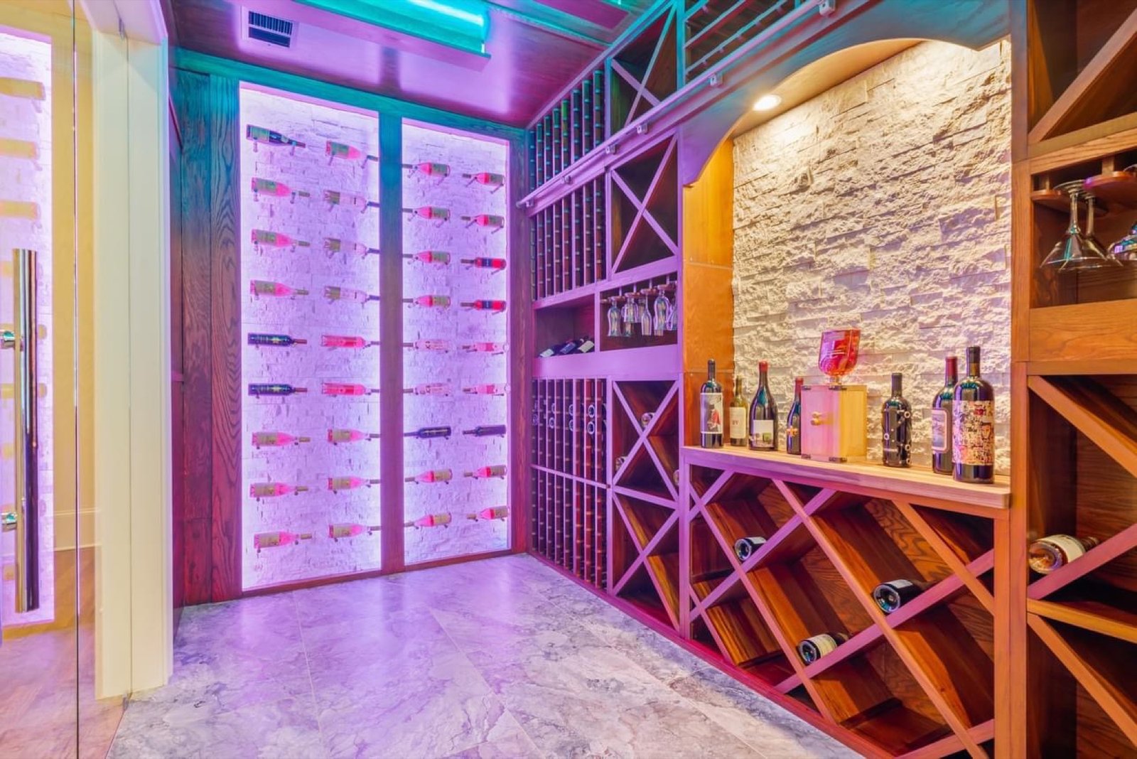 Custom basement wine room with display lighting by GHIR Construction in Cumming, GA